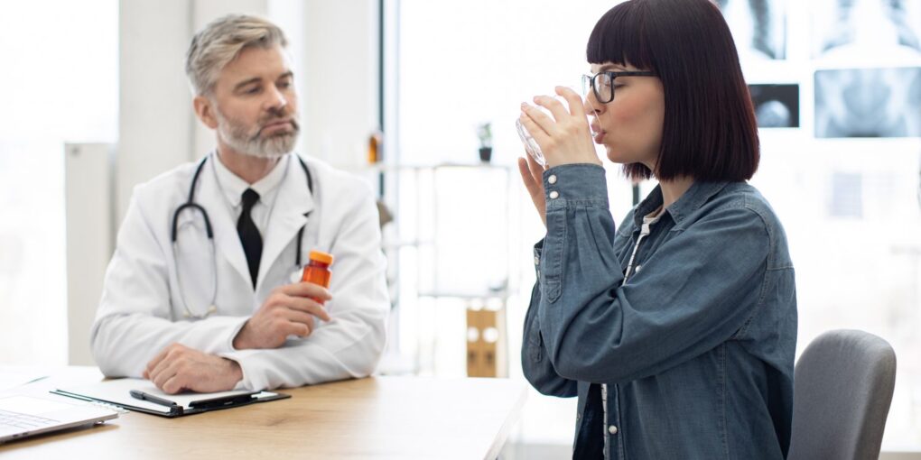 Médecin discutant avec une patiente de symptômes pouvant évoquer une allergie à la pénicilline.